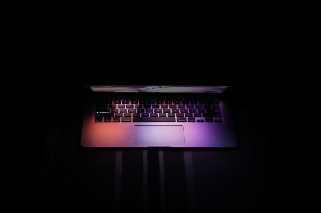 writer typing on laptop at night